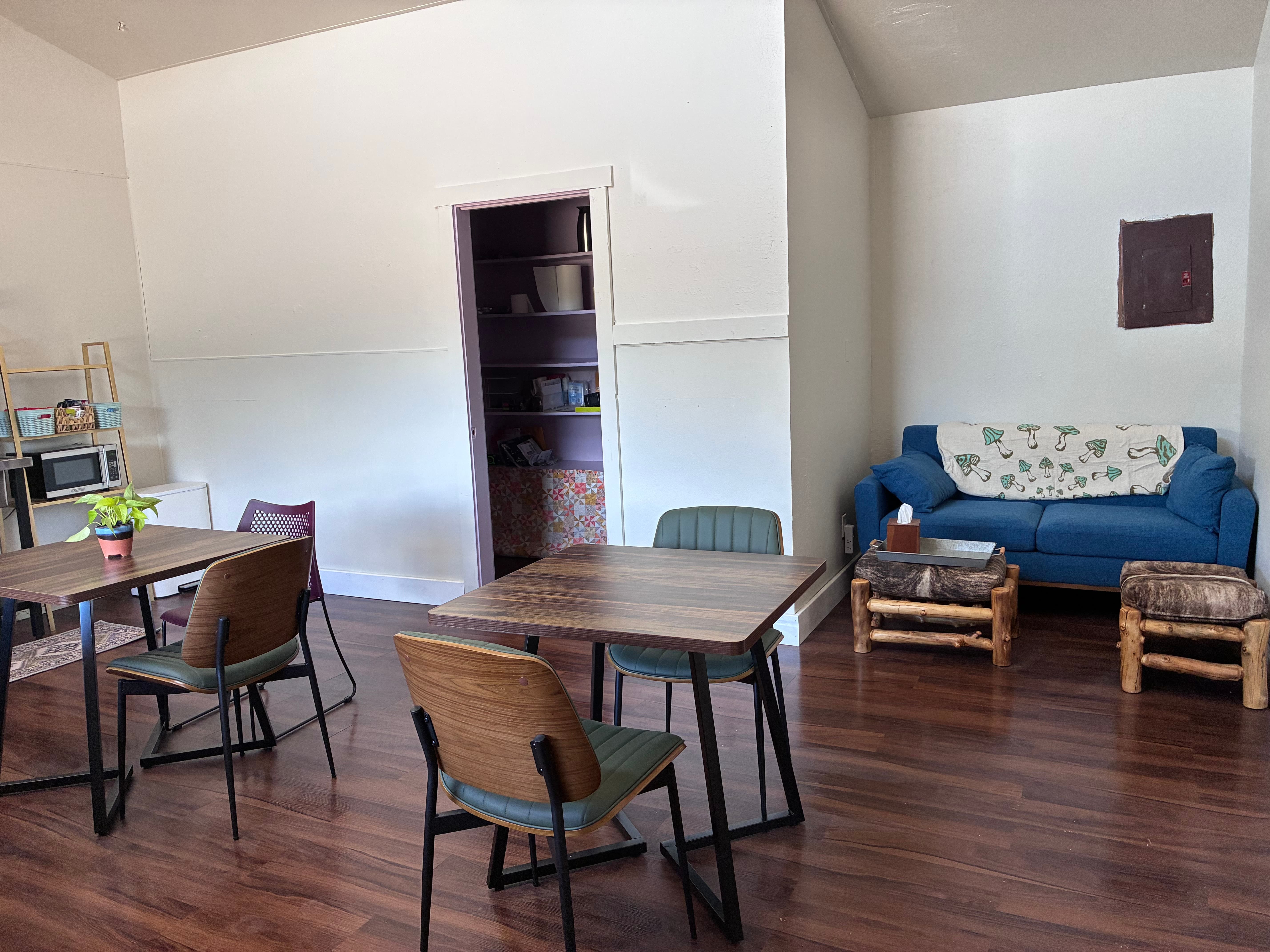 Kitchenette with coffee maker, kettle, microwave, and seating for breaks